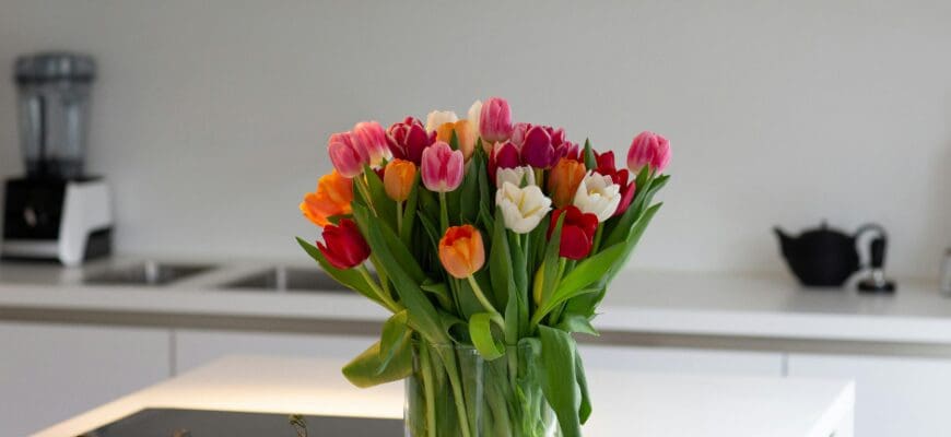 White Kitchen Counter with a Flower Bouquet in a Glass vase